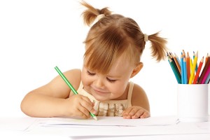 Cute child draw with color pencils and smile